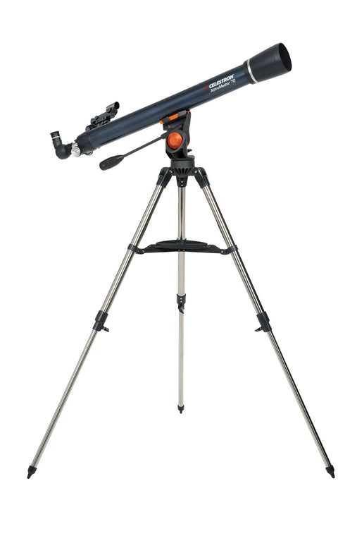 A Celestron AstroMaster 70AZ telescope with a long, blue cylindrical tube mounted on a gray altazimuth mount and silver tripod. The telescope is angled slightly upward for observation. The mount includes an orange adjustment knob and a control handle for positioning the telescope