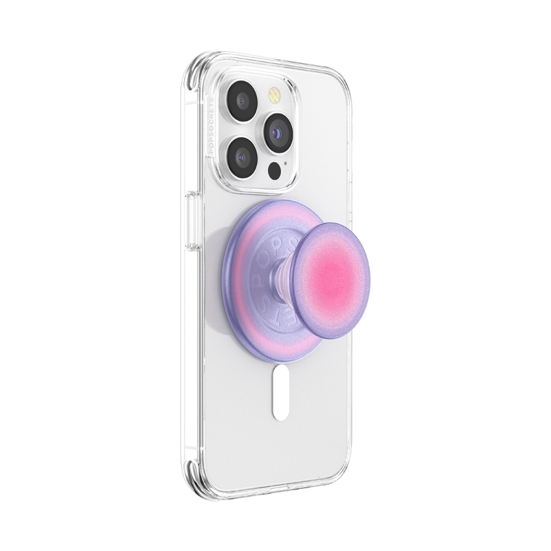 A smartphone with a clear case is shown with an Aura PopGrip for MagSafe attached to its back. The PopGrip is extended, showcasing its functional grip, with a gradient color pattern transitioning from pink in the center to purple on the edges. The phone's camera lenses are visible at the top, highlighting the PopGrip's stylish and colorful design, which complements the phone's aesthetics while providing a practical grip for easier handling.