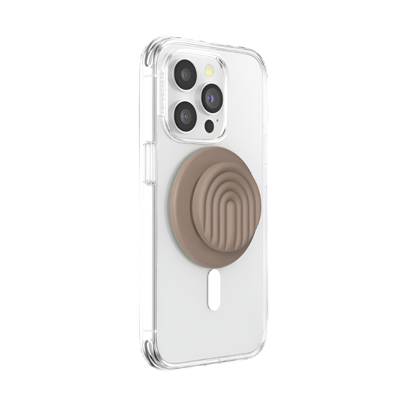 A clear phone case is shown attached to a smartphone with a PopOut Latte Curves PopGrip for MagSafe. The PopGrip, featuring a latte-colored design with curved lines, is retracted, providing a compact and stylish hold for the device