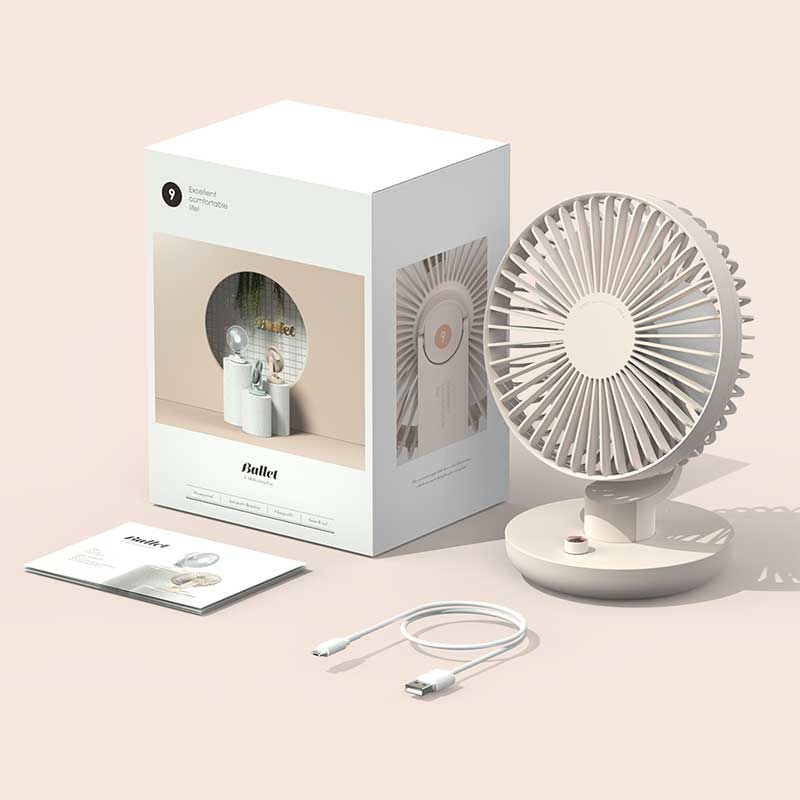 A beige desk fan with a modern, minimalist design displayed alongside its packaging, a USB charging cable, and a user manual. The fan features a circular blade enclosure, a small button on its round base, and a tilting mechanism. The packaging showcases an image of the fan and highlights its features. The setup is placed on a light beige surface, creating a clean and cohesive aesthetic.