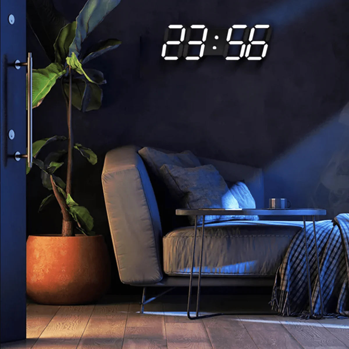 A modern living room with a cozy corner setup. A comfortable beige armchair with a blue throw blanket and several pillows is placed next to a sleek metal coffee table. Above the chair, a digital wall clock with large illuminated numbers displays the time. A tall potted plant in a terracotta pot adds a touch of greenery to the space. The room is dimly lit with a soft blue light, creating a relaxing and inviting atmosphere.
