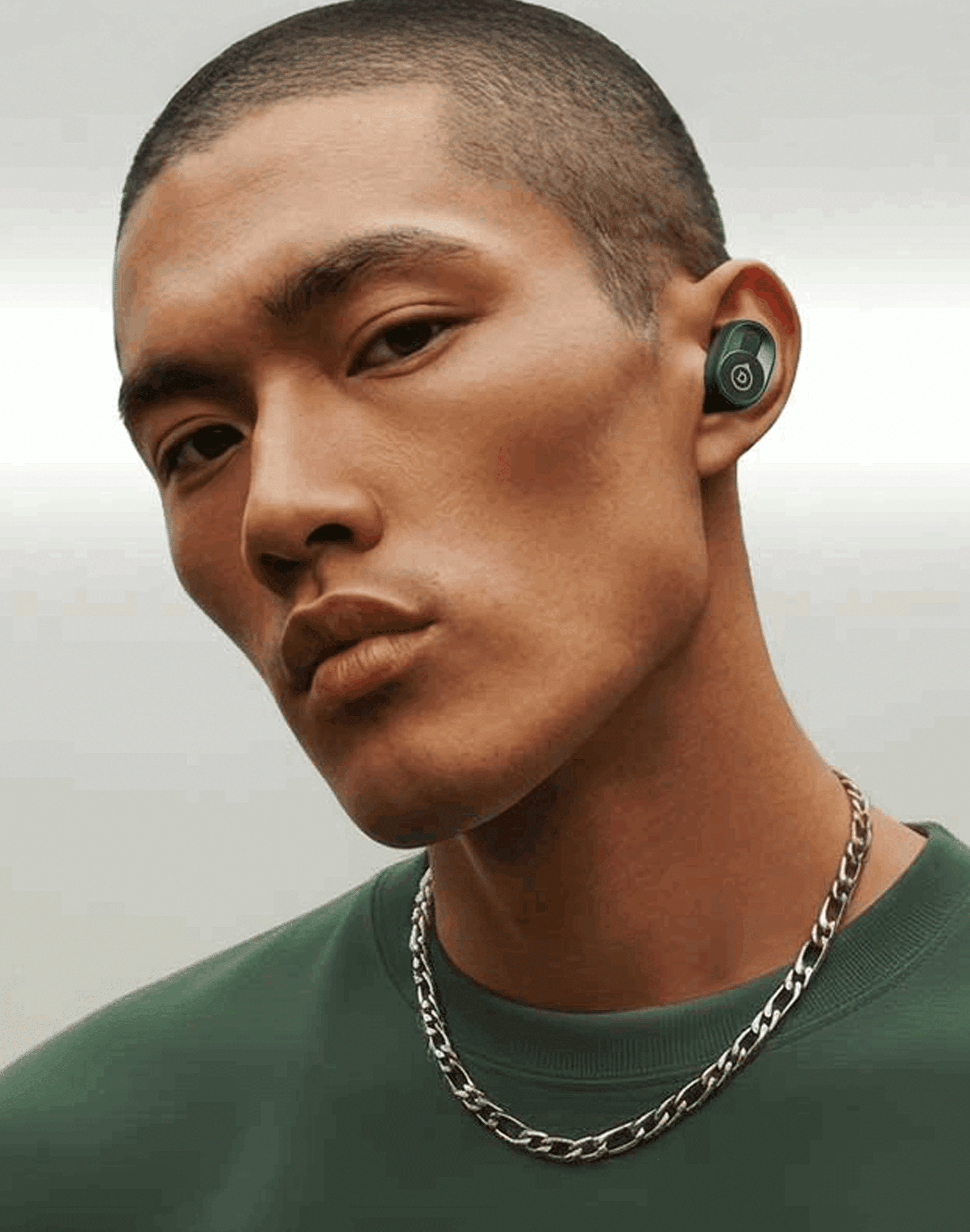 Devialet Gemini II Deep Forest earbuds lifestyle shot