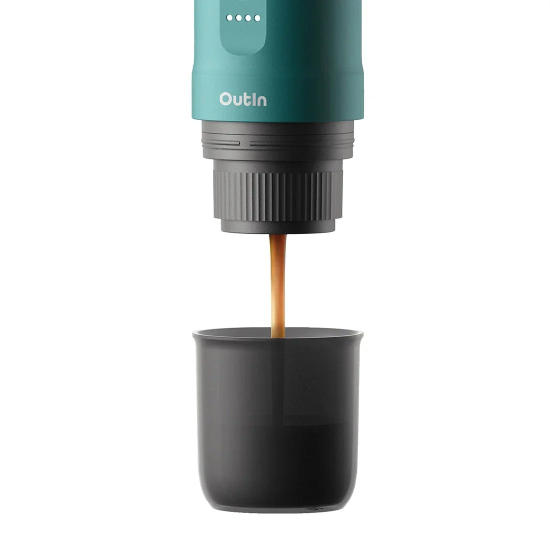 OutIn Nano OutIn Teal extracting espresso with crema into cup