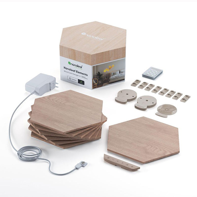 This image showcases the components of a **Nanoleaf Elements** smart lighting system. The wooden hexagonal light panels are spread out, with additional accessories such as a power adapter, connector links, and mounting hardware. The packaging box is visible in the background, displaying the Nanoleaf branding and product information. The hexagonal shapes of the light panels contribute to the modular and customizable nature of the setup, allowing users to create various patterns on their walls. The soft wood