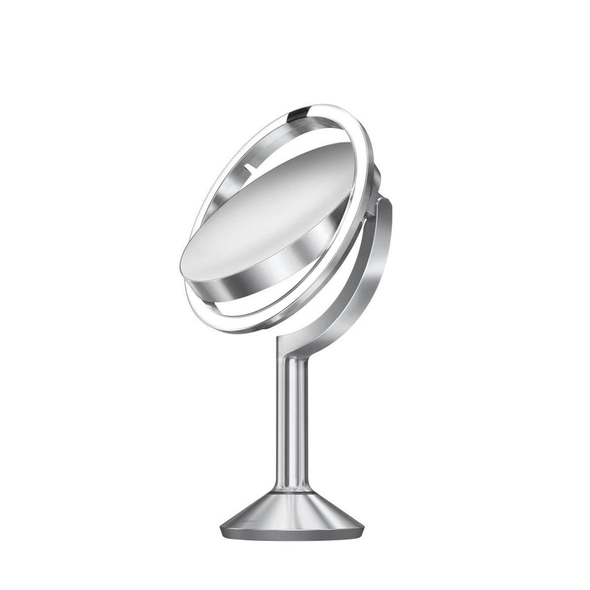 This image shows the **Simplehuman sensor mirror** from a dynamic angle, showcasing its **adjustable dual-sided mirror**. The mirror's **ring light** provides uniform illumination, making it ideal for grooming and makeup applications. The **sleek, brushed metal design** complements its modern aesthetic while ensuring durability. The flexible mount allows users to rotate and tilt the mirror, ensuring it can be angled perfectly for detailed viewing.
