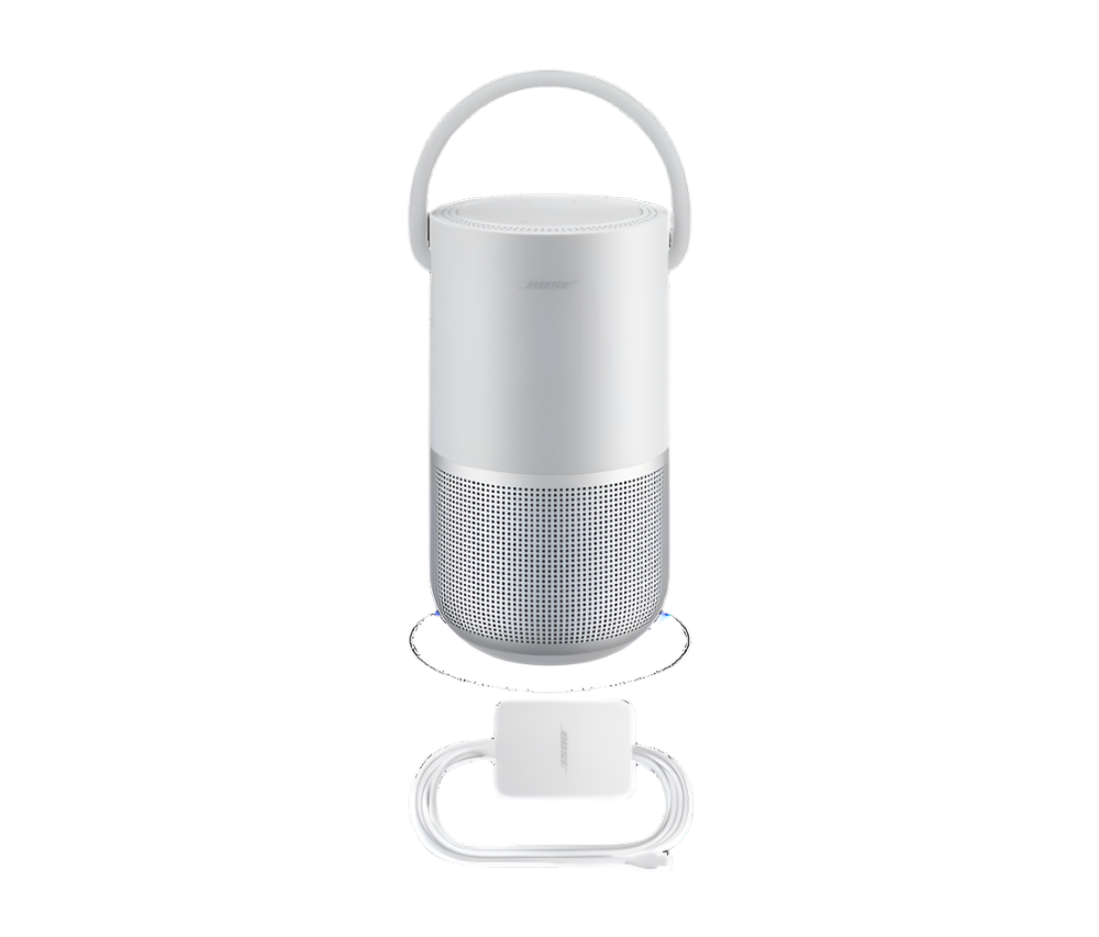 This image features a white Bose portable speaker with a handle on top, allowing for easy carrying. Below the speaker, there is a charging cable and adapter, also in white, designed to complement the sleek, modern design of the speaker. The overall presentation emphasizes portability and ease of use, characteristic of Bose's high-quality audio products.