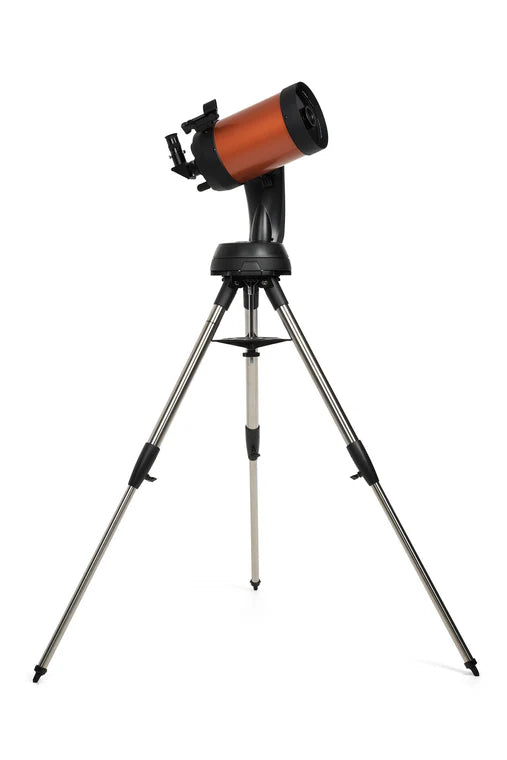 A Celestron NexStar 6SE telescope with an orange cylindrical tube mounted on a black computerized base and a silver tripod. The telescope is angled slightly upward for observation. The tripod provides a stable and adjustable platform, while the computerized base offers advanced tracking and alignment capabilities.