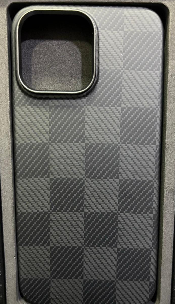 This image shows a phone case with a textured, carbon fiber-like checkerboard pattern, similar to previous cases you've shared. The case has a large rectangular cutout, which appears to be for a multi-lens camera setup, suggesting compatibility with a higher-end smartphone model. The sleek design and refined texture give it a modern, minimalist look that offers both style and protection for the device. This case is likely aimed at users who appreciate both functionality and a sophisticated aesthetic.