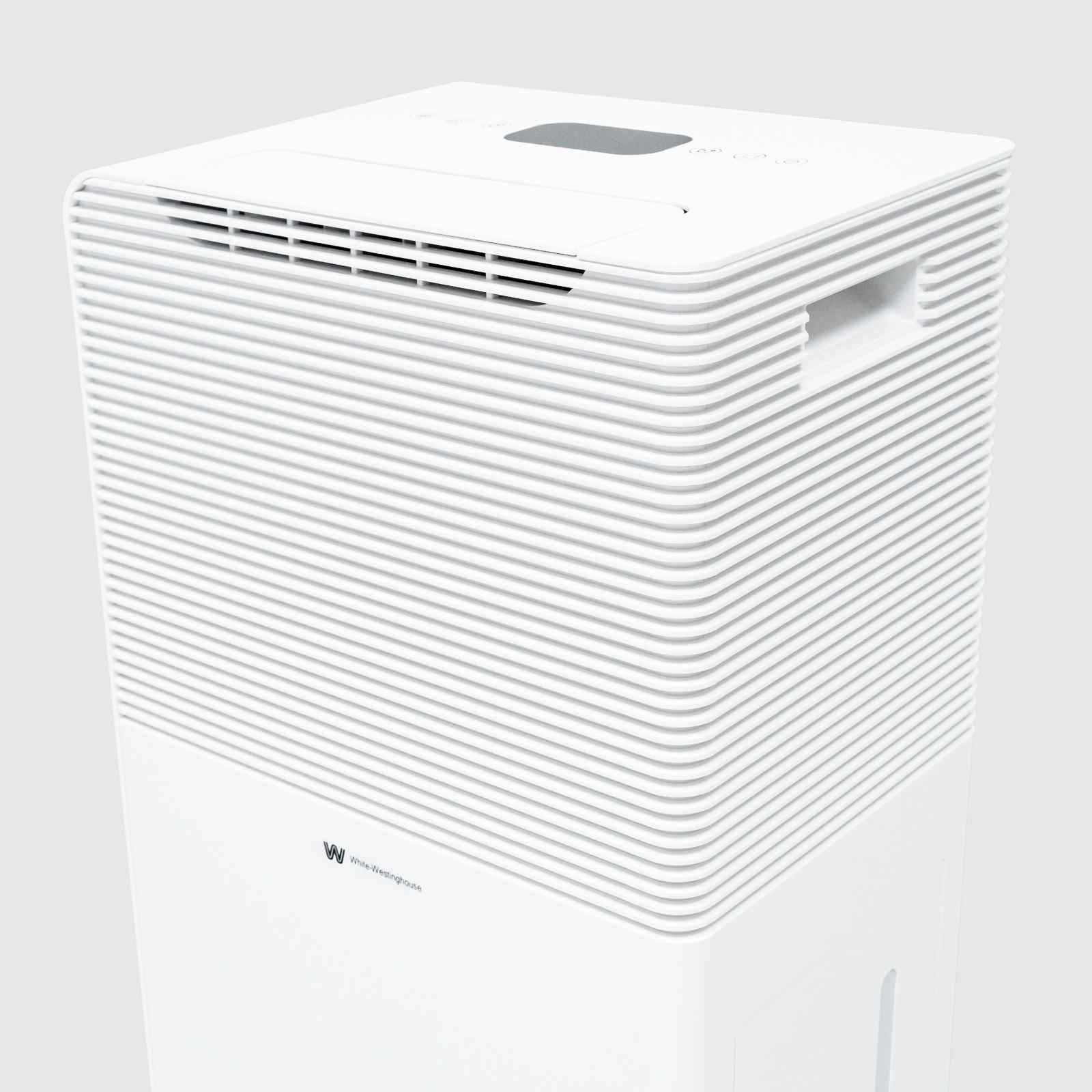 Top angled view of the White Westinghouse Dehumidifier AWHD40, showcasing the air vents, digital control panel, and built-in handle for easy mobility. The sleek white design is suitable for maintaining optimal humidity levels in residential and commercial spaces.