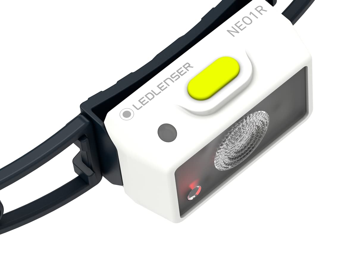  A close-up view of a LED Lenser NEO1R headlamp. The headlamp has a white front housing with the LED Lenser logo and model name "NEO1R" printed on it. It features a yellow button on top for operation, a black adjustable strap, and a prominent LED lens in the center. The headlamp is designed for compact and efficient lighting.