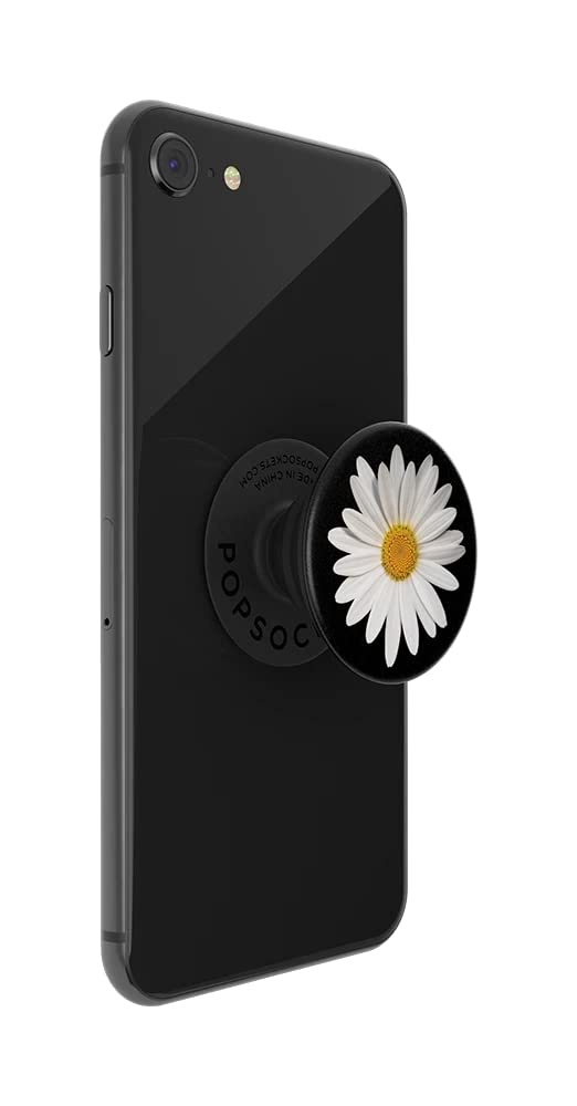 A black smartphone with a PopSockets phone grip attached to the back. The PopSockets grip is expanded and features a white daisy with a yellow center, set against a black background. The daisy design adds a touch of floral elegance to the phone's sleek appearance, and the grip provides added functionality for holding the phone securely.