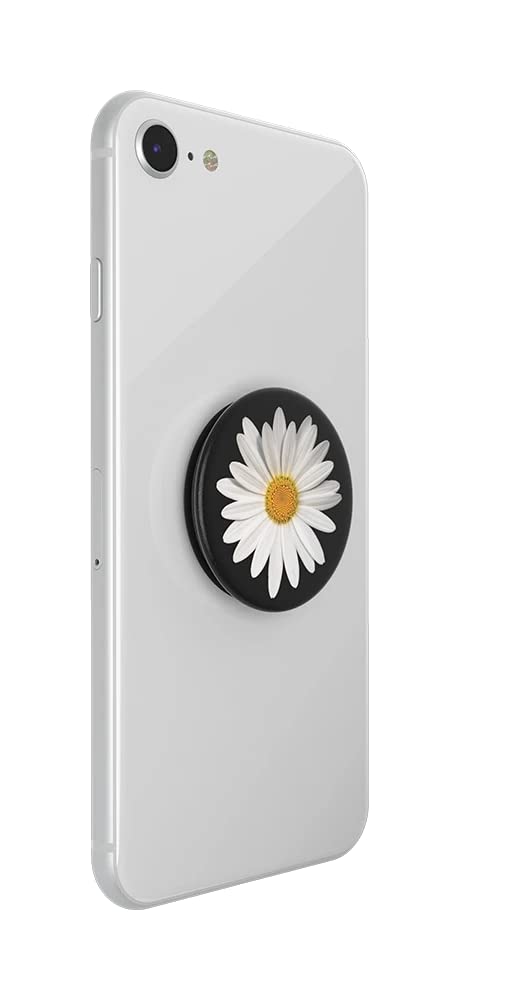 A white smartphone with a PopSockets phone grip attached to the back. The PopSockets grip is expanded and features a white daisy with a yellow center, set against a black background. The daisy design adds a touch of floral elegance to the phone's sleek appearance, and the grip provides added functionality for holding the phone securely.