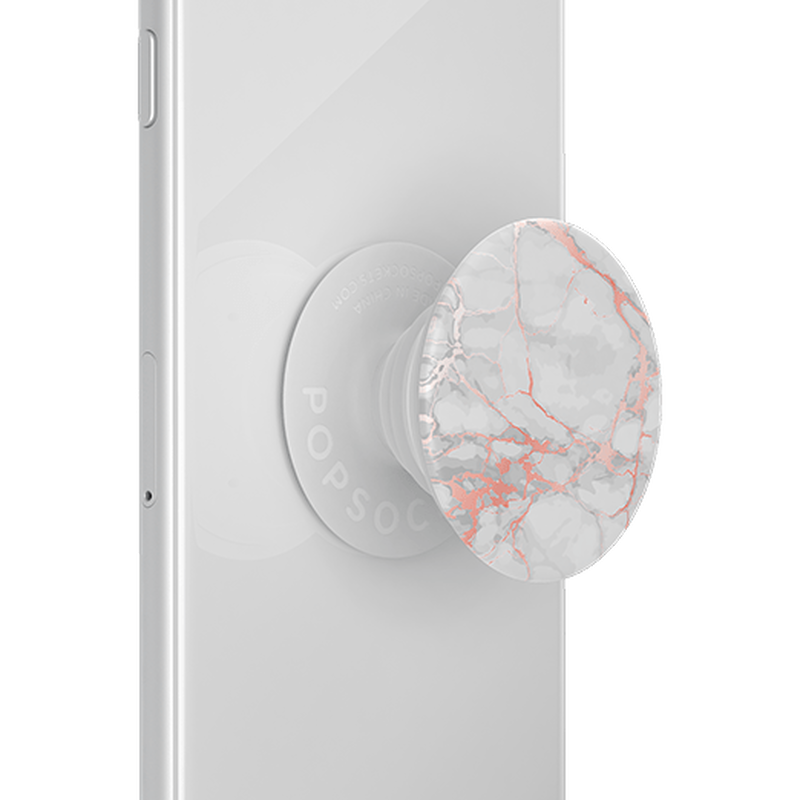 A PopSockets PopGrip with a Rose Gold Lutz Marble design attached to the back of a white smartphone. The grip features a white and light grey marble pattern with rose gold veining, shown in its expanded state for better grip and stand functionality.