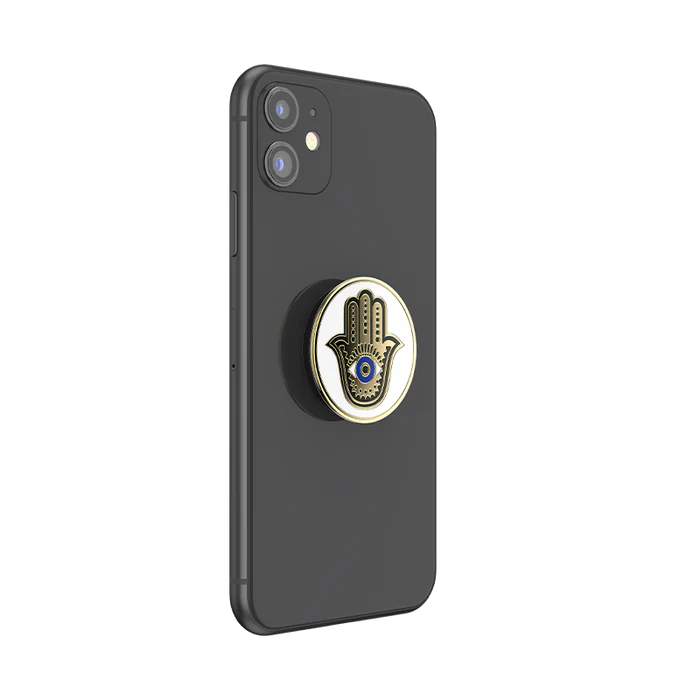 A black smartphone with a PopSocket attached to the back. The PopSocket features a design of a Hamsa hand with an eye in the center.