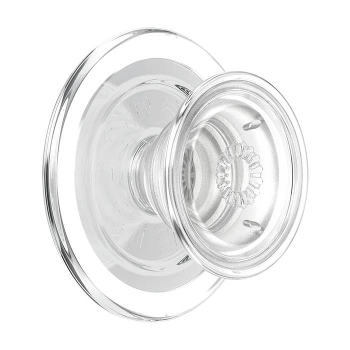 A PopSockets Clear PopGrip for MagSafe is shown against a plain background. The PopGrip features a round, transparent surface with a clear base and extendable grip. The design highlights its modern and sleek appearance while being compatible with MagSafe technology, allowing for easy attachment and removal from a MagSafe-compatible device. The inner ring has the PopSockets logo, emphasizing the brand's identity.