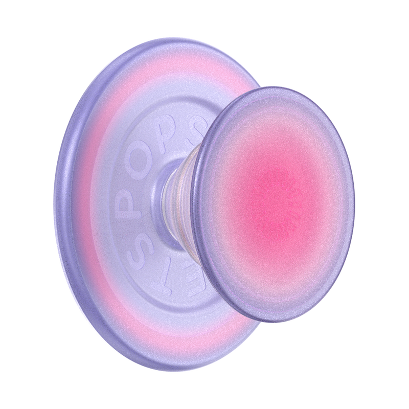 An Aura PopGrip for MagSafe is shown against a plain background. The grip features a round, flat surface with a gradient color pattern transitioning from pink in the center to purple on the edges. The design includes a transparent base and an extendable grip, both infused with the gradient color, giving the PopGrip a stylish and colorful appearance. The grip is designed to be compatible with MagSafe technology, allowing for easy attachment and removal from a MagSafe-compatible device.