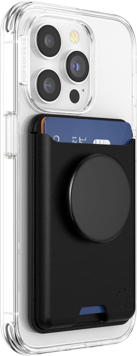 A black PopSockets Softgoods Phone Wallet with an expanding grip and adapter ring for MagSafe, attached to the back of a clear phone case. The wallet is holding a blue card, and the expanding grip is in its retracted position.