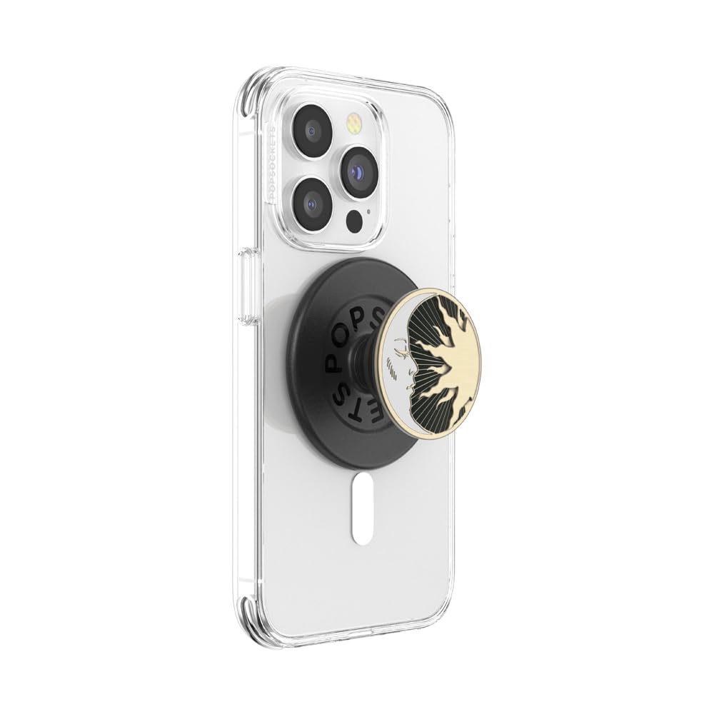 The image features a **clear MagSafe-compatible phone case** with a **black PopSocket base** magnetically attached. The PopSocket grip displays an intricate **gold and black celestial sun-and-moon design**, adding elegance and a stylish touch. This setup combines functionality and visual appeal, offering a secure grip and easy magnetic detachment for convenience.