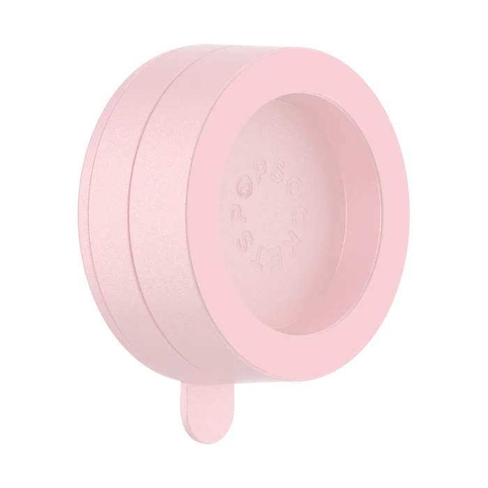 A PopSockets Suction Mount for MagSafe in a dusty rose color is shown against a plain background. The mount features a circular design with the PopSockets logo embossed on the inner surface. A small tab extends from the bottom, likely for easy removal or adjustment. The soft pink hue gives the mount a delicate and modern appearance.