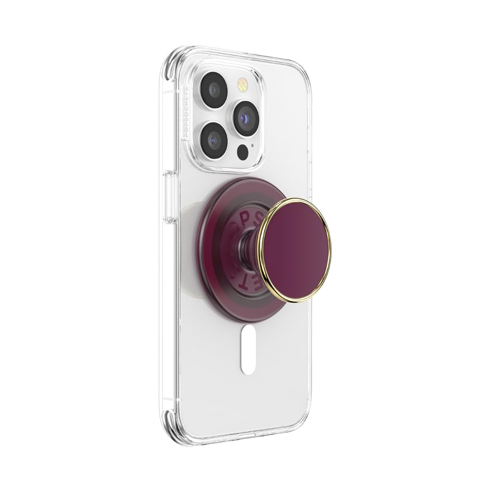 A smartphone with a clear case featuring an extended maroon PopSocket grip with a glossy circular top accented by a gold metallic rim, offering both style and functionality for secure handling and versatile use.