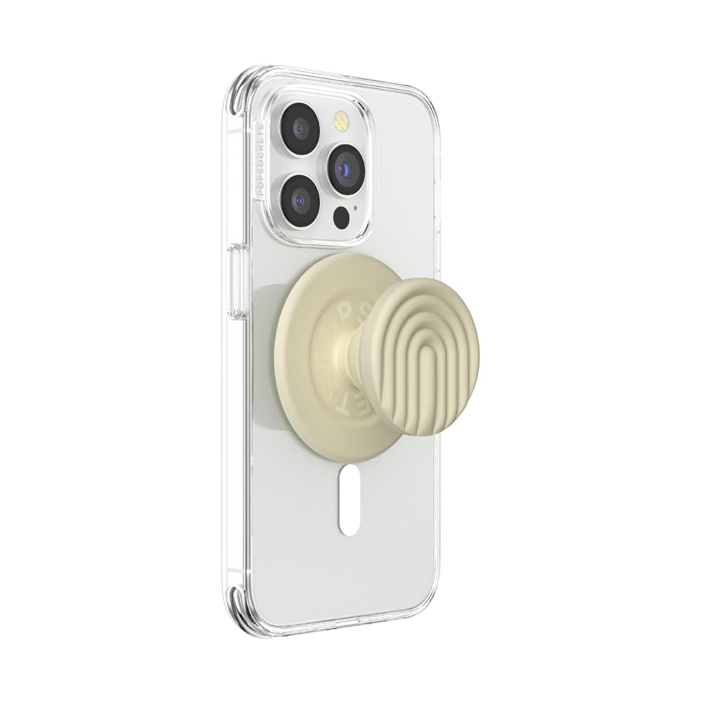 This image shows a clear MagSafe-compatible phone case with a beige PopSocket featuring a raised, modern arch pattern design for ergonomic grip and style. The PopSocket is attached magnetically to the back of the phone case for easy removal and use.