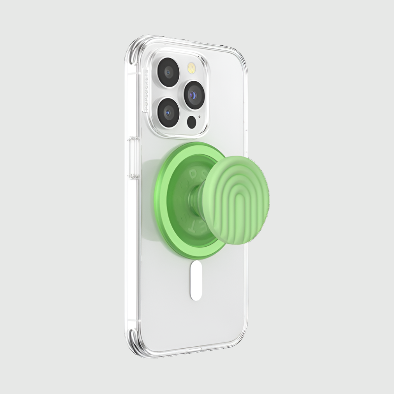 Clear smartphone case with a Popsockets Silicone PopGrip MagSafe in Matcha Dew color, featuring a circular design and a raised grip for holding. The PopGrip is designed for MagSafe compatibility, providing a secure and convenient way to hold the phone