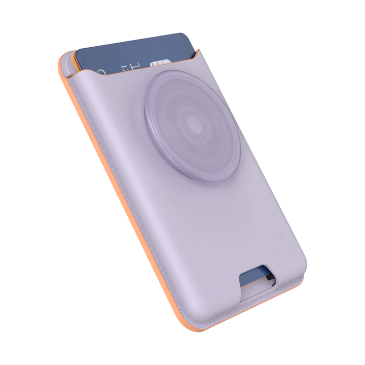  A PopSockets MagSafe Softgoods PopWallet in Pale Lavender color shown from an angled side view. The wallet has a credit card partially inserted in the top slot. The attached PopSocket, also in pale lavender, is prominently displayed. The side stitching in a contrasting color adds detail to the soft material, emphasizing its stylish and modern design. The PopSockets logo is embossed near the bottom corner.