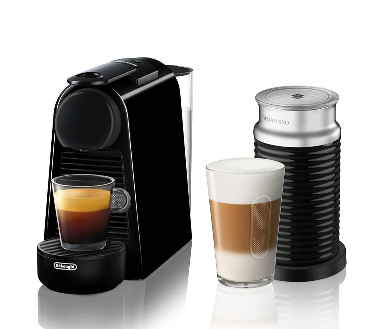 A compact black Nespresso coffee machine alongside a milk frother, with a glass of espresso and a layered latte showcasing the machine's capabilities.