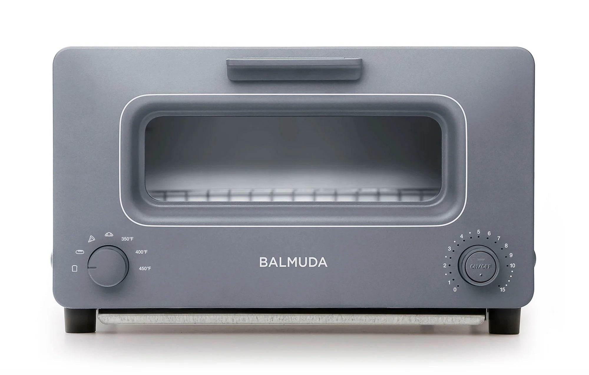 The image shows a front view of the Balmuda toaster in a cool, matte gray finish. The toaster features a large rectangular viewing window, bordered by a matching gray accent. The brand name "BALMUDA" is centered in silver lettering below the window