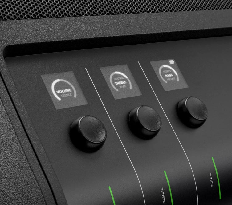 : Close-up view of the control panel on a Bose speaker. The panel features three black knobs for adjusting volume, treble, and bass. Above each knob, there are corresponding digital indicators that display the current settings for volume, treble, and bass. The design is sleek and modern, emphasizing easy and precise control over the audio settings.