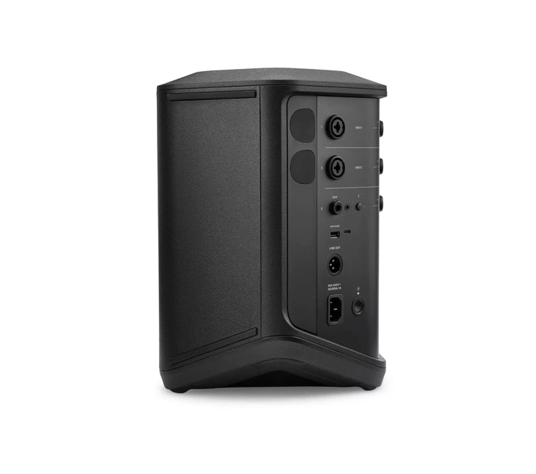 : Side view of a black Bose speaker showing its input/output ports and control panel. The ports include two XLR/TRS combo jacks, a 3.5mm auxiliary input, a USB port, and a power input. The design is sleek and functional, with all controls and connections neatly organized on one side of the speaker. The overall design emphasizes portability and ease of use.