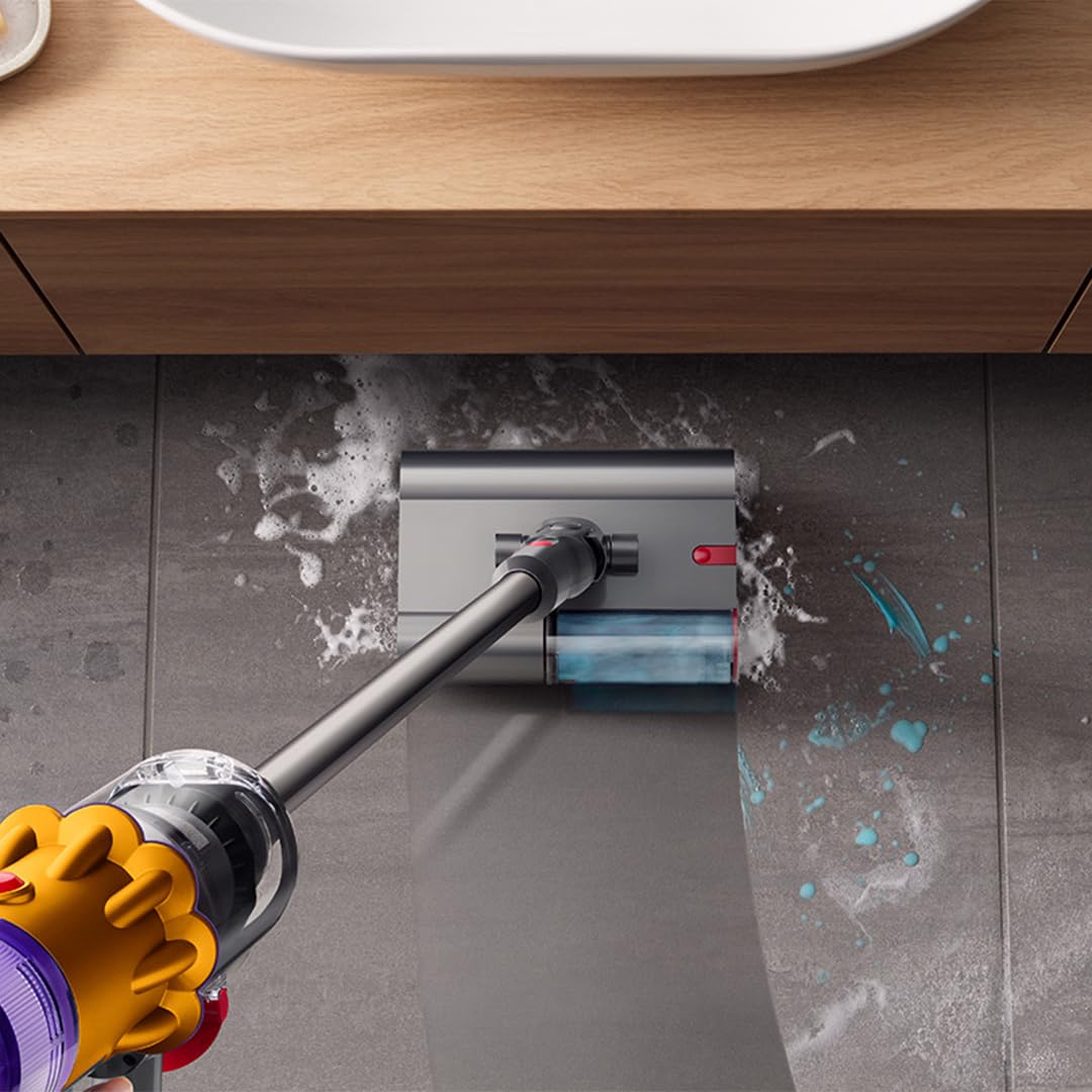 Cordless vacuum cleaner with wet and dry cleaning capability, efficiently removing spills from tiled floors.