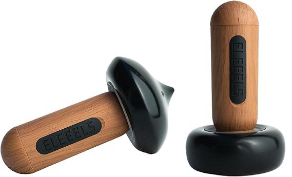 Two ELEEELS S2 Hot Stone Massage Wands are displayed: one with a flat black base and another with a pointed precision base. Both feature ergonomic wooden handles engraved with the "ELEEELS" logo, showcasing their versatility and sleek design.