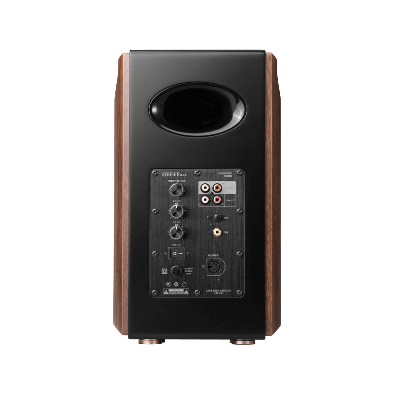 This image shows the rear panel of a high-end speaker, featuring input/output ports, control knobs, and a bass reflex port at the top. The panel includes multiple connectivity options such as RCA inputs, XLR connectors, and volume/bass/treble adjustments for versatile audio setup. The wood finish on the sides enhances its premium aesthetic appeal.