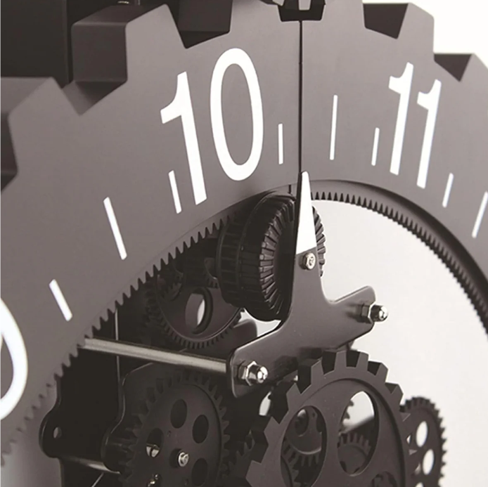 Close-up view of a mechanical gear clock, highlighting the large black gear with white numerals and the intricate network of gears and mechanisms working together beneath, emphasizing the industrial and detailed craftsmanship.