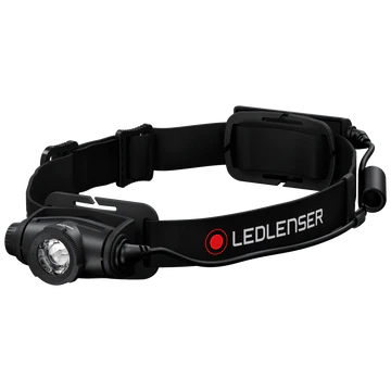  A black LED Lenser headlamp with an adjustable strap, shown at an angle. The headlamp features a prominent central light, an adjustable focus ring, and a battery pack attached to the back of the strap. The LED Lenser logo is visible on the strap. The background is white, emphasizing the headlamp's design and details.