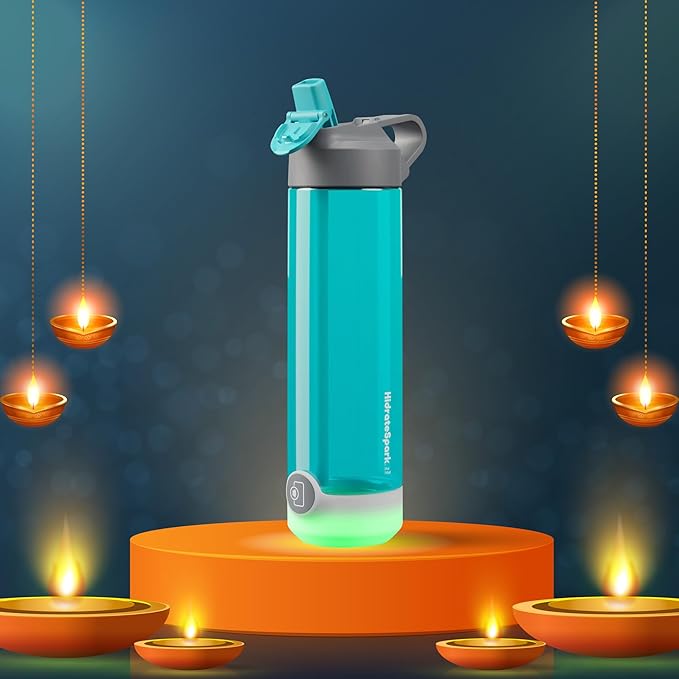 A glowing aqua-colored smart water bottle is featured on an elevated orange platform surrounded by traditional Diwali oil lamps, creating a festive ambiance. The illuminated base of the bottle harmonizes with the warm hues of the lamps, symbolizing a blend of modern hydration technology with the spirit of the Diwali celebration.