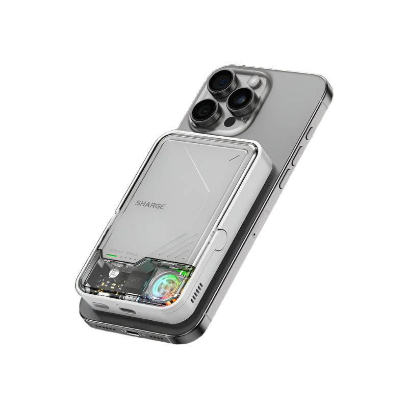 A SHARGE portable power bank attached magnetically to the back of a smartphone, showcasing its sleek, compact design. The transparent section reveals internal components, including an RGB-lit cooling fan. The power bank offers a 10000mAh capacity with 30W fast charging support, providing efficient and stylish on-the-go power for mobile devices.