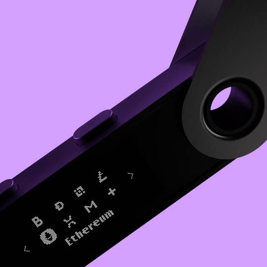 The image provides a close-up view of the Ledger Nano S Plus hardware wallet, highlighting its screen and design features. The device is angled, with the display screen showing various cryptocurrency icons and the word "Ethereum" in a dot-matrix font. The circular hole at the top of the device is also visible, likely for attaching a lanyard or keychain. The background is a soft purple, which contrasts nicely with the black finish of the Ledger device, emphasizing its modern and sleek design.