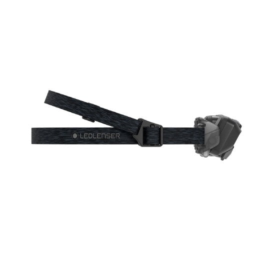 Side view of a LED Lenser headlamp with an adjustable strap, highlighting its compact design and secure fit for various head sizes.