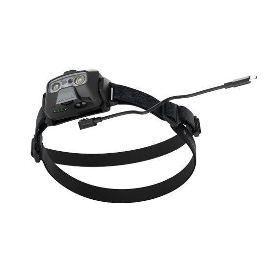 A LED Lenser headlamp with an adjustable strap, showcasing its USB charging capability and advanced lighting features designed for outdoor and industrial use.