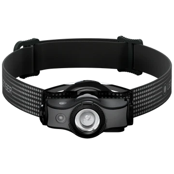 : A black LED Lenser headlamp with an adjustable strap is shown from the front. The strap features a dotted pattern and the "LED LENSER" branding. The headlamp unit has a central clear lens and buttons for operation, designed for hands-free illumination. The strap is designed to provide a secure and comfortable fit around the head.