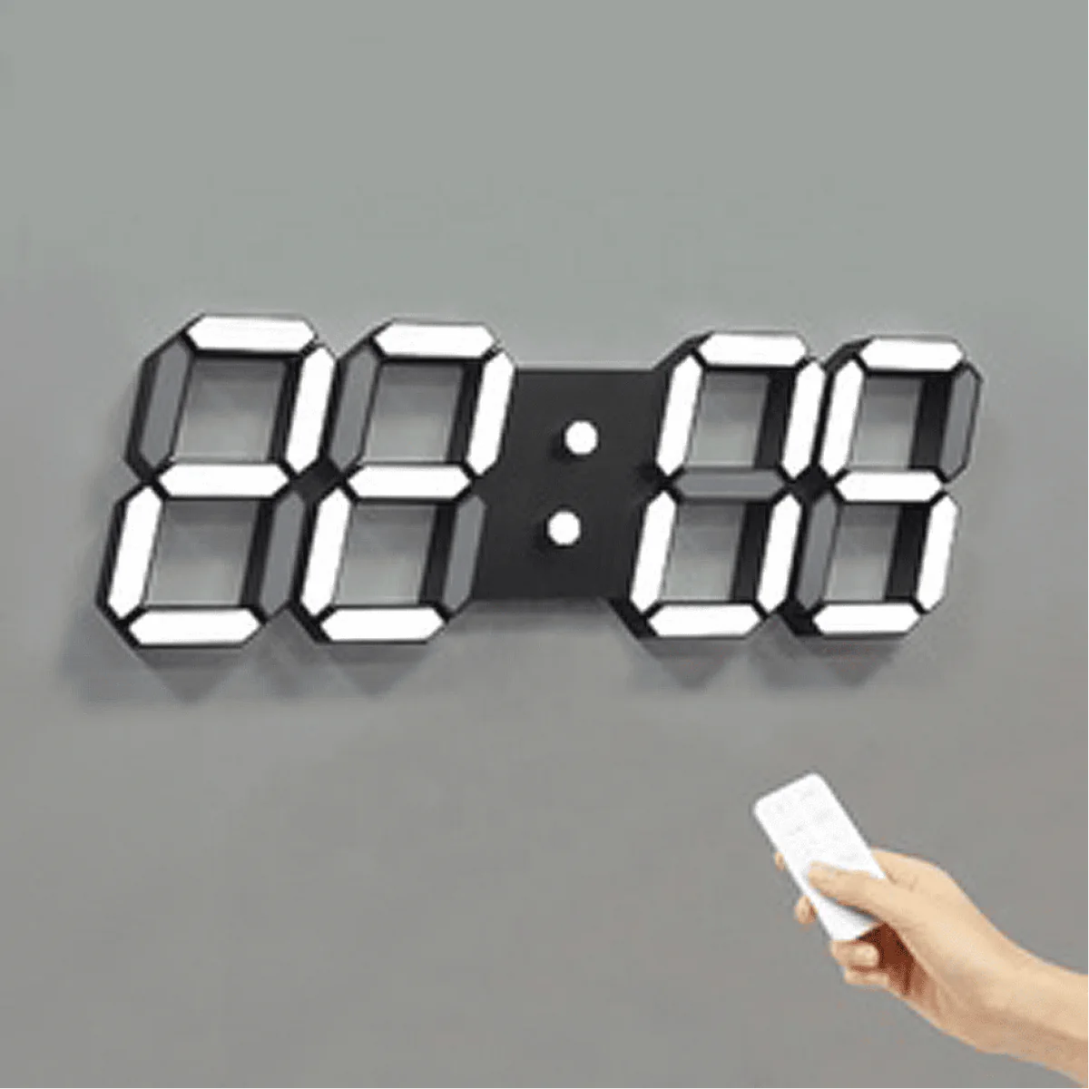  A digital wall clock with large illuminated numbers is mounted on a gray wall. The clock is displaying "88:88." A hand holding a remote control is aimed at the clock, suggesting the use of the remote to set or adjust the clock. The clock has a sleek, modern design with bright, easily readable numbers.