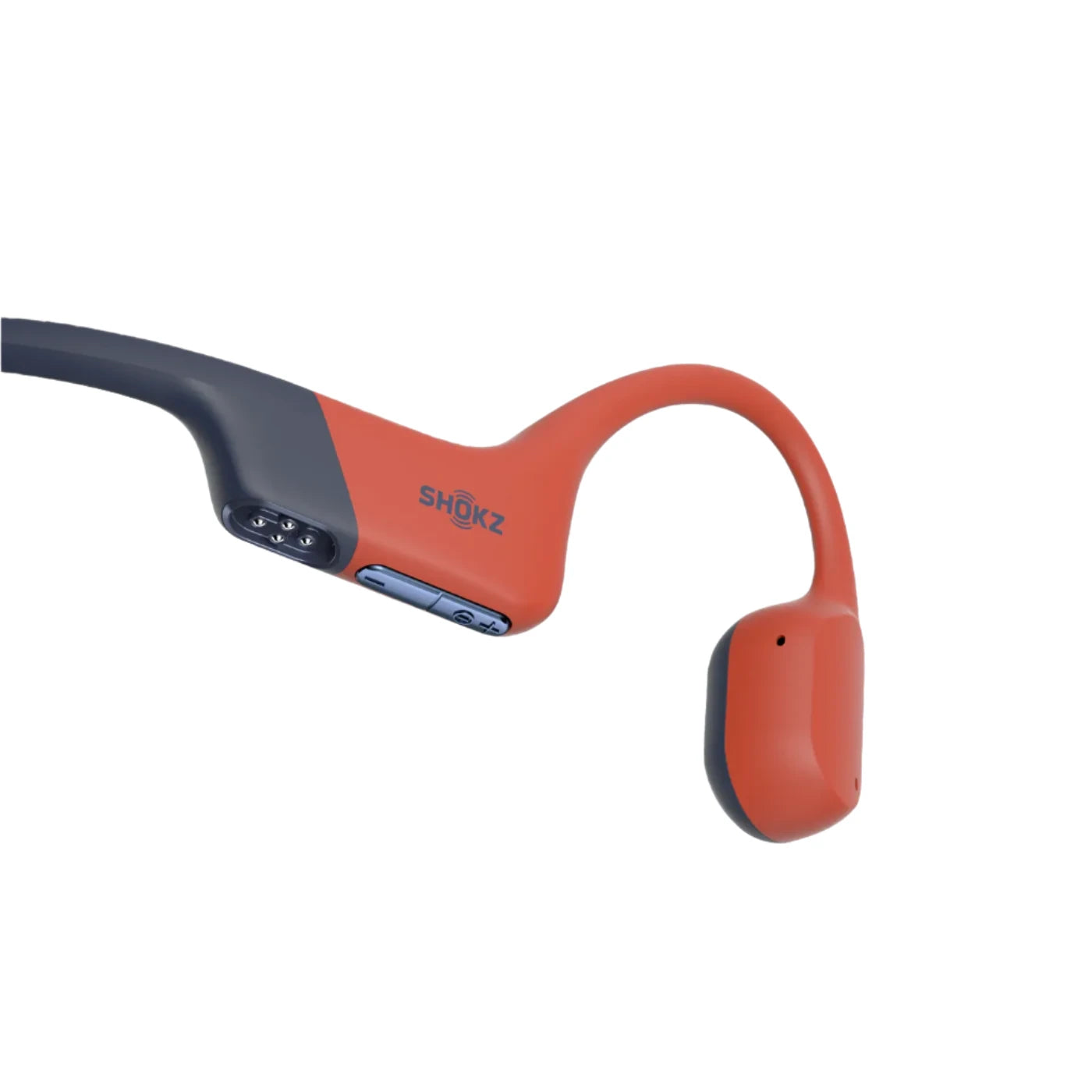 Close-up of Shokz bone conduction headphones in orange and navy, featuring control buttons and magnetic charging port for easy operation and water resistance.