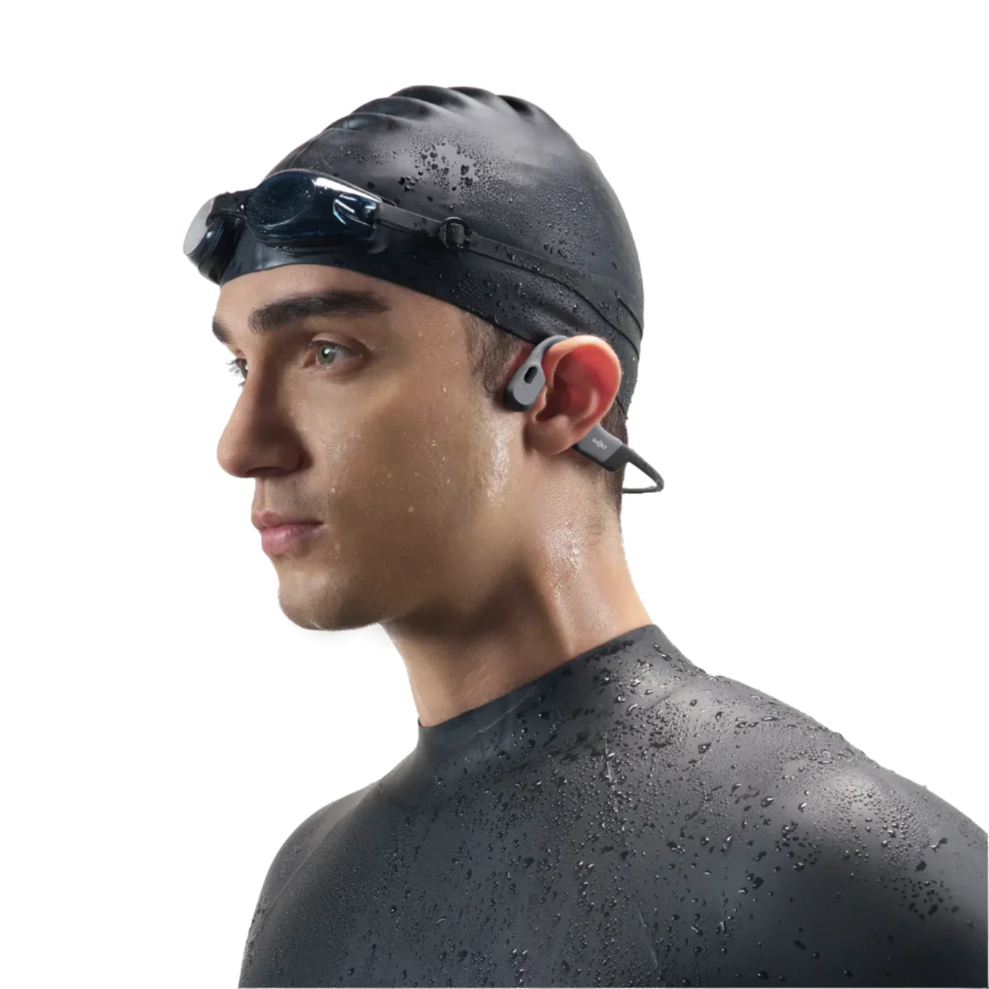 Swimmer wearing Shokz bone conduction headphones, designed for water resistance and secure fit during aquatic activities.