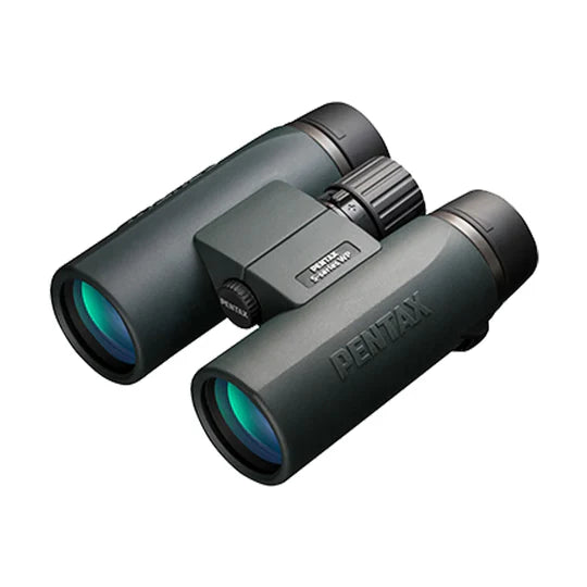  A pair of Pentax SD 10x42 ED binoculars with a sleek, ergonomic design. The binoculars have large objective lenses with a greenish tint and a durable body with a matte finish. The Pentax branding is visible on the side of the right barrel. The central focusing wheel is positioned between the two barrels for easy adjustment. The binoculars are designed for comfortable grip and handling, emphasizing high-quality optics and durability.