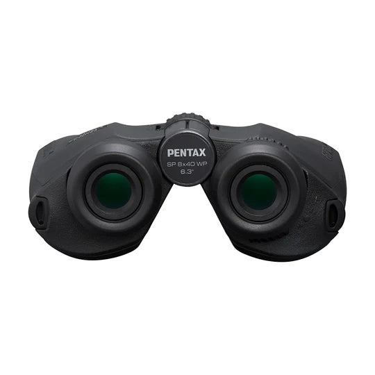  A front view of Pentax SP 8x40 WP binoculars showing the eyepiece lenses. The central focusing wheel, labeled with "PENTAX SP 8x40 WP 6.3°," is prominently visible. The binoculars have a rugged design with textured surfaces for a secure grip. The eyecups are designed for comfortable viewing, and the overall design emphasizes durability and ease of use.