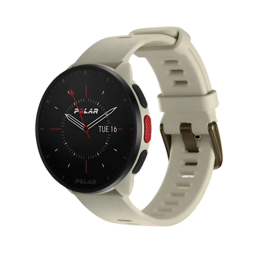 A Polar Pacer smartwatch with a round face displaying a traditional analog-style clock interface with white hour markers, red minute and second hands, and the date. The watch has a white casing and a matching white strap with a buckle closure. The strap features multiple adjustment holes for a secure fit. The side of the watch has a red button and textured black grips for easy operation.