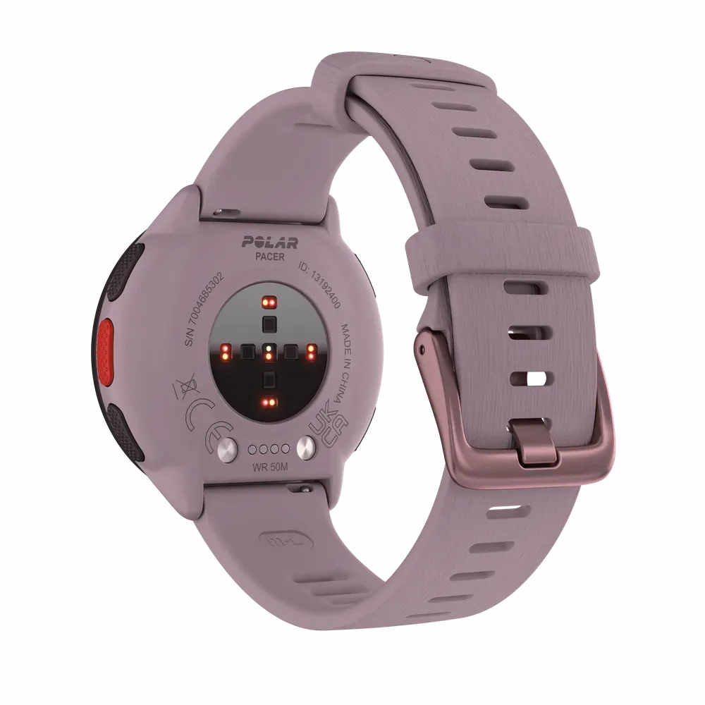  The back view of a Polar Pacer smartwatch showing its heart rate sensors and charging ports. The watch has a purple casing and a matching purple strap with a buckle closure. The strap features multiple adjustment holes for a secure fit. The watch's branding and specifications are visible on the back.