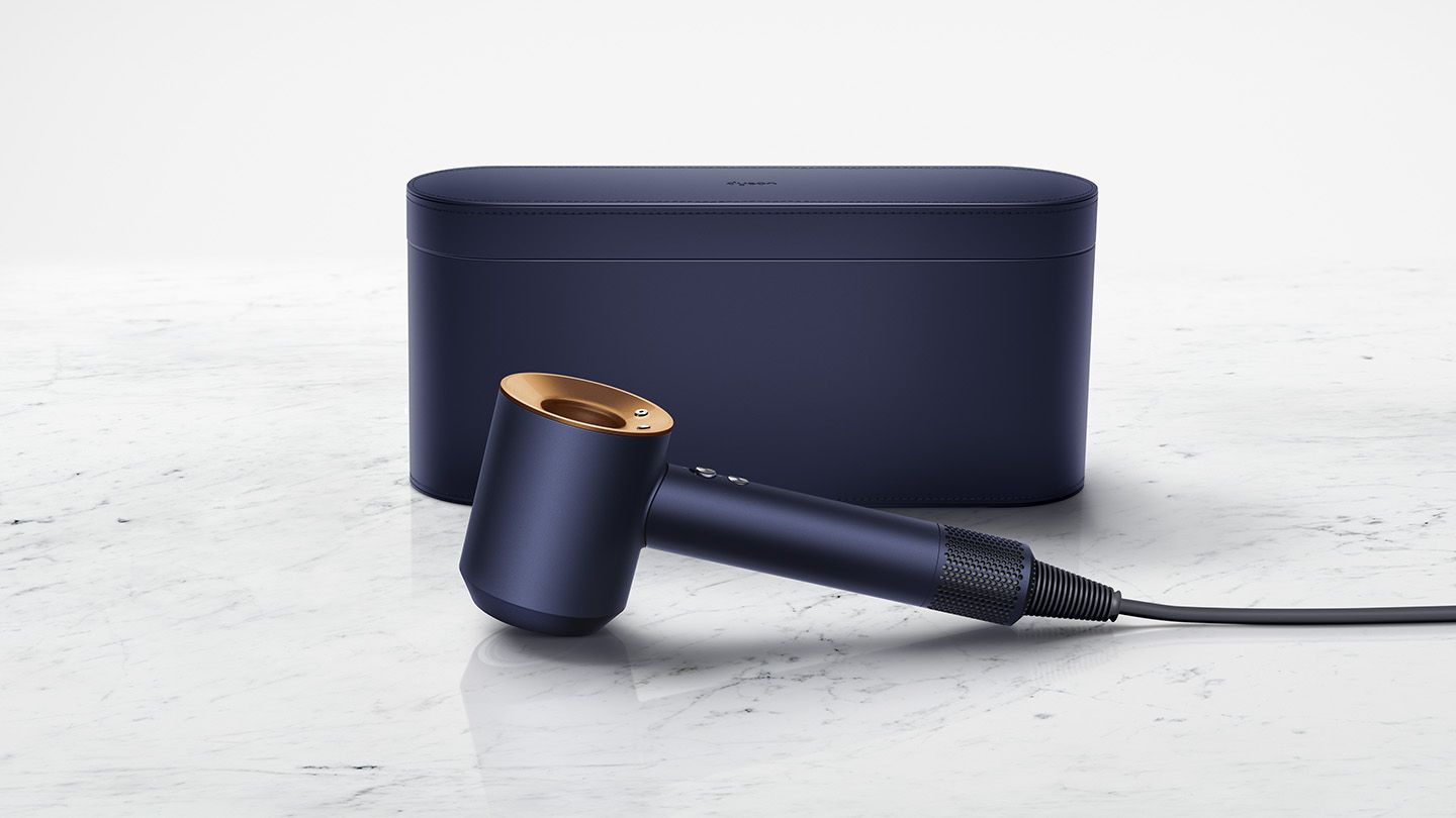 This image features a sleek hair styling tool in a sophisticated navy and gold color combination, complemented by a matching storage case. The stylish and elegant design showcases modern aesthetics, ideal for those who value both performance and luxury in their hair care appliances.